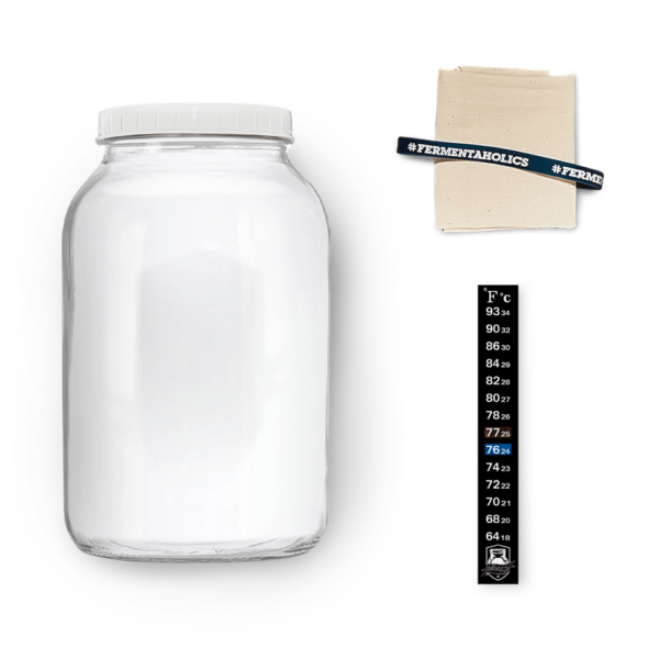 one gallon glass kombucha jar with muslin cloth and rubber band
